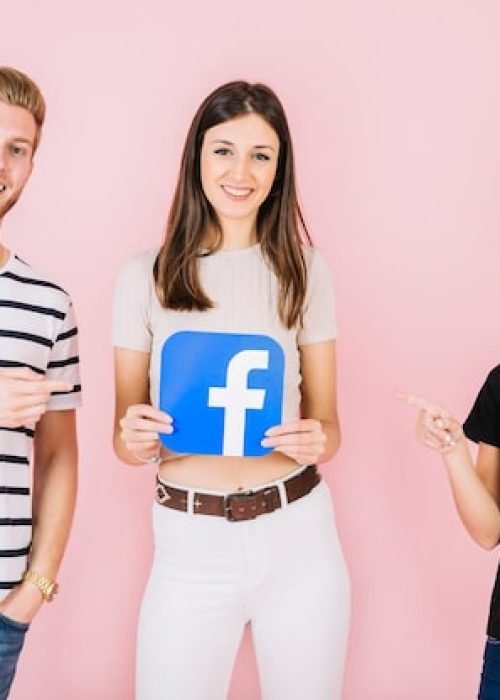 man-woman-pointing-their-friend-holding-facebook-icon-pink-backdrop_23-2147849425